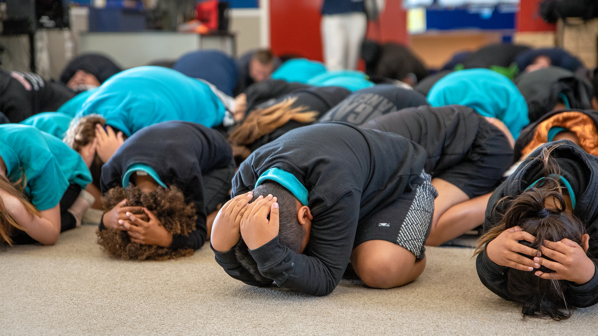 Primary school students doing Drop Cover Hold